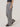 Person wearing gray wide-leg pants on a plain background