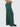 Green wide-leg pants worn by a person on a white background