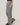 Person wearing gray wide-leg pants on a plain background