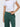 Person wearing green pants and a white cropped top on a light gray background